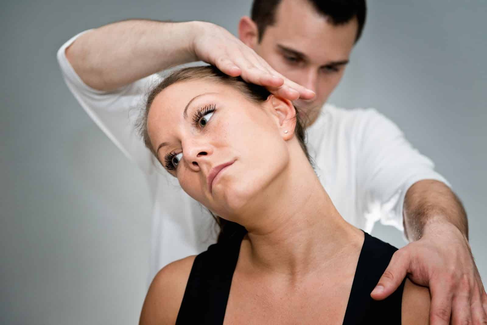 a chiropractor adjusting a woman's spine